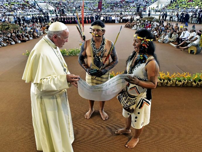 Handout picture released by the Vatican press office Osservatore Romano showing Pope Francis greets representatives of indigenous communities of the Amazon basin from Peru, Brazil and Bolivia in the Peruvian city of Puerto Maldonado, on January 19, 2018. Pope Francis sounded a stark warning about the future of the Amazon and its peoples during a visit to the region on Friday, saying they had "never been so threatened." In a speech to thousands of tribe members on the edge of the rainforest in Peru, he said the Amazon and its peoples bore "deep wounds". / AFP PHOTO / OSSERVATORE ROMANO AND AFP PHOTO / HO / RESTRICTED TO EDITORIAL USE - MANDATORY CREDIT "AFP PHOTO / OSSERVATORE ROMANO" - NO MARKETING NO ADVERTISING CAMPAIGNS - DISTRIBUTED AS A SERVICE TO CLIENTS